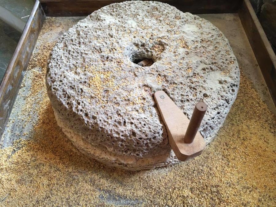close-up of old stone hand mill at 'Narlis Farm'